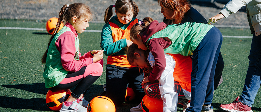 Young girls playing football