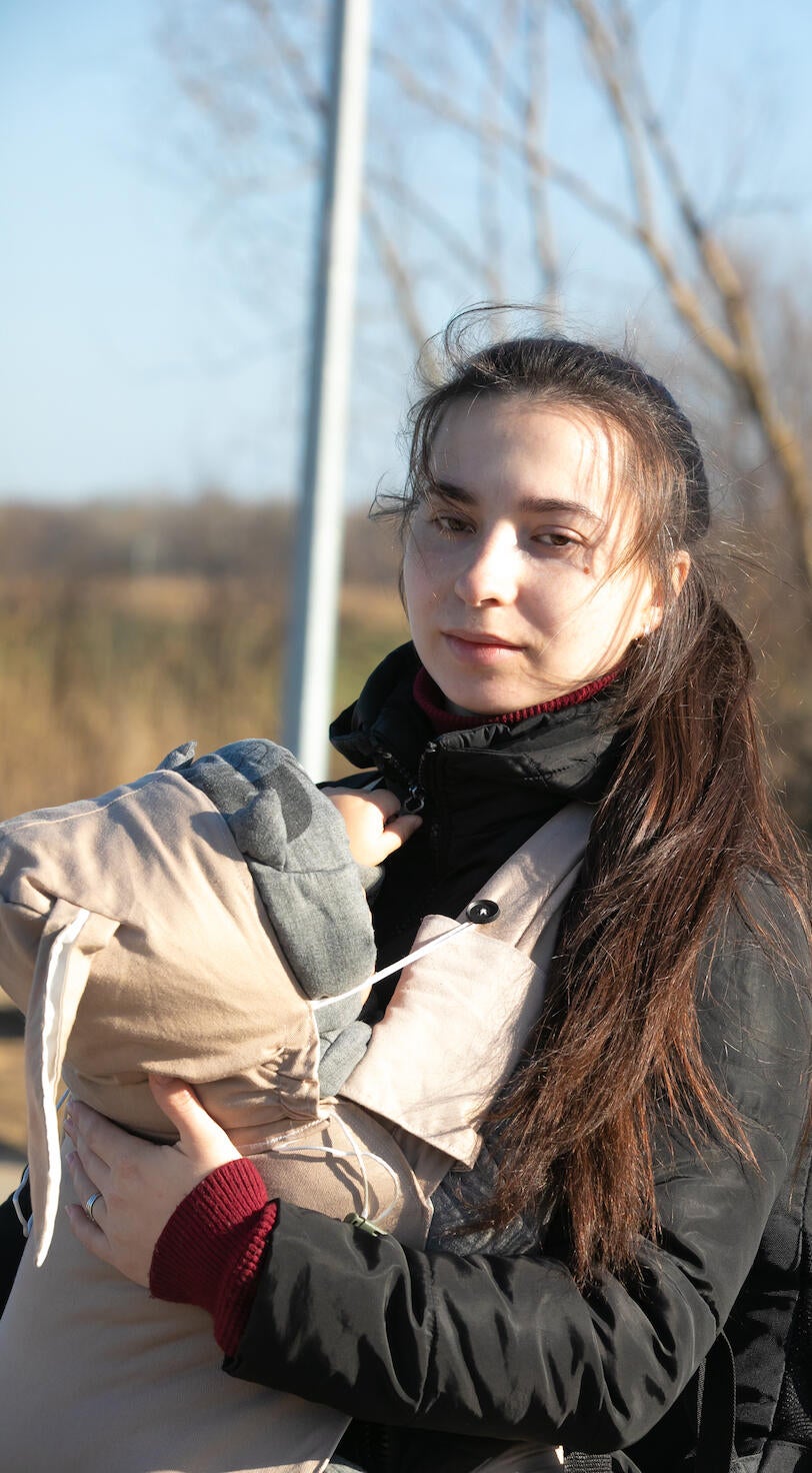 A young mother holds her child.