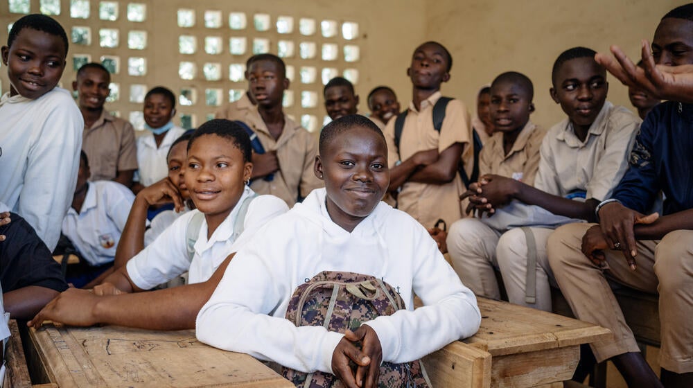 Group of children smiling in a classroom.